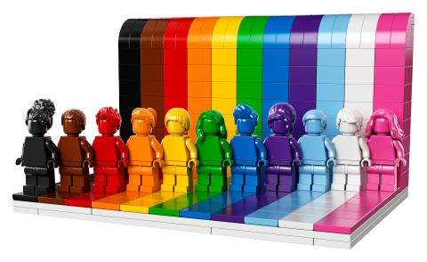 rainbow pride-themed LEGO characters standing in front of a rainbow LEGO background