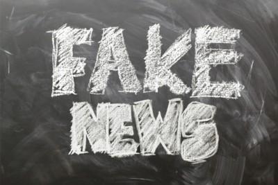 Chalkboard with phrase "fake news" written on it