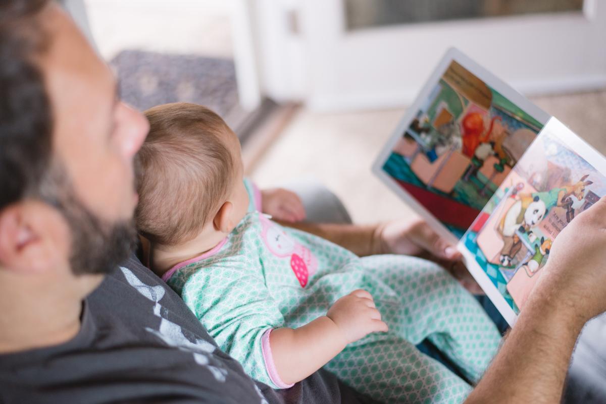 Caregiver reading to a baby